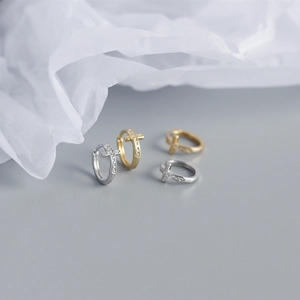 Detail of S925 sterling silver hoop earrings with zircon cross charms in gold and silver