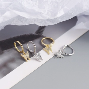 Macro detail of S925 sterling silver butterfly hoop earrings with sparkling crystal pavé