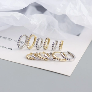Detailed macro view of S925 sterling silver hoop earrings with purple zircon inlays