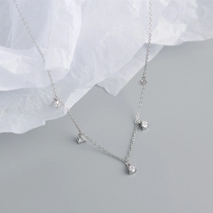 Close-up of S925 sterling silver necklace featuring five round-cut cubic zirconia pendants