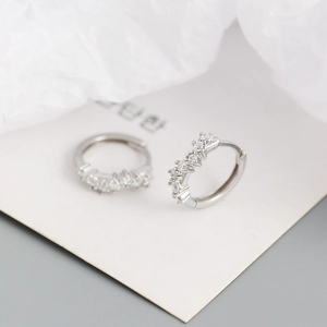 Macro detail of S925 sterling silver hoop earrings with sparkling cubic zirconia pavé