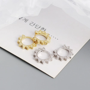 Detail showing S925 silver geometric hoop earrings in gold and silver with pave zircon