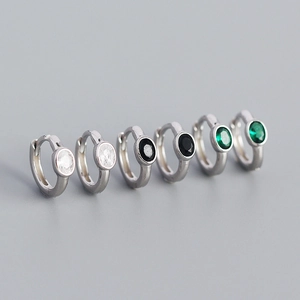 Minimalist S925 sterling silver huggie earrings with oval zircon stones in three colors