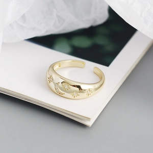 Macro detail of gold vintage moon and star ring with sparkling cubic zirconia stones