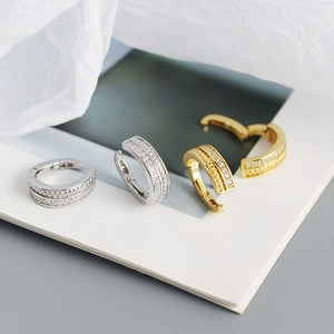 Detail of silver and gold twisted ear cuffs with sparkling micro-paved cubic zirconia