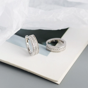 Detail of s925 silver hoop earrings featuring double-row sparkling cubic zirconia stones