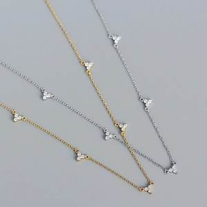 Three minimalist S925 silver necklaces with triple zircon stones in gold and silver finishes
