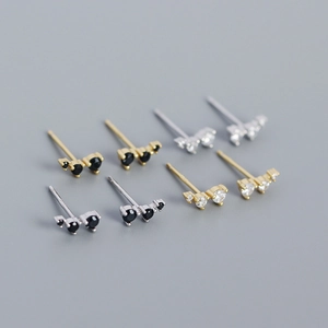 Close-up of S925 silver stud earrings set with black and clear cubic zirconia rows