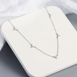 Close-up of S925 sterling silver necklace featuring delicate three-stone zircon pendants