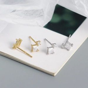 Macro shot of S925 sterling silver square zircon stud earrings in gold and silver