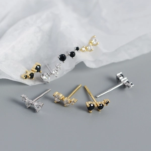 Macro shot of s925 silver stud earrings set with black and white zircon stones