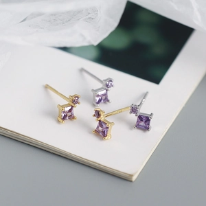 Detailed macro of S925 silver square purple zircon earrings in gold and silver finish