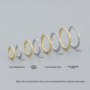 Macro shot of S925 sterling silver hoops with 925 hallmark in gold and silver finishes