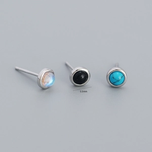 Macro detail of 5.5mm geometric stud earrings in moonstone, black stone and turquoise