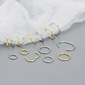 Macro detail of seamless S925 sterling silver hoop earrings with visible 925 hallmarks