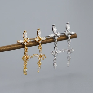 Detailed view of gold and silver butterfly tassel earrings with marquise-cut zircons