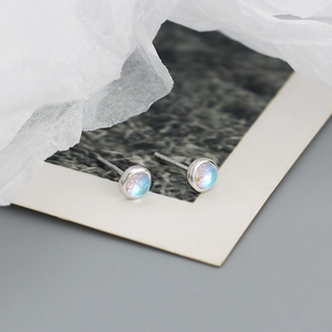 Macro shot of S925 sterling silver stud earrings with round iridescent gemstone cabochons