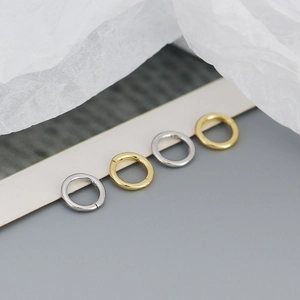 Detailed macro of S925 sterling silver hoop earrings in gold and silver finish