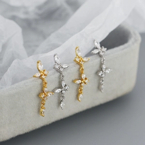 Close-up of s925 silver and gold butterfly tassel earrings with sparkling zircons