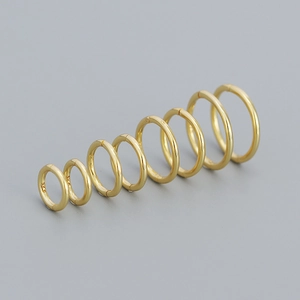 Set of 7 gold-plated S925 sterling silver hoop earrings in varying sizes on grey background