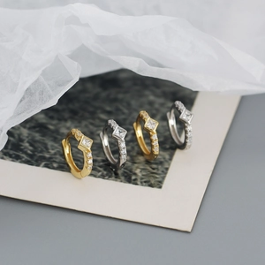 Detail of s925 silver hoop earrings with square zircon stone in gold and silver finish