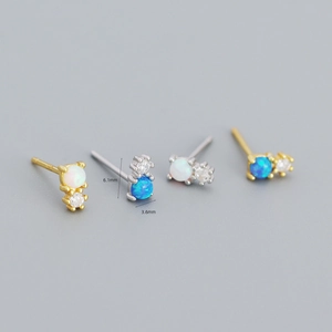 Macro view of geometric S925 silver stud earrings with opal and cubic zirconia stones