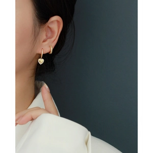 Close-up of elegant 18K gold-plated heart earrings with shimmering zircon pave setting