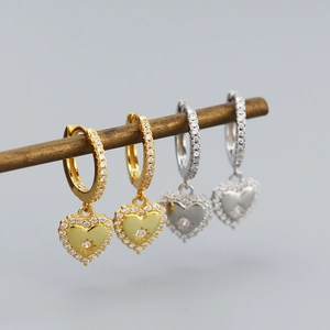 Detailed close-up of heart-shaped earrings featuring micro-paved cubic zirconia stones