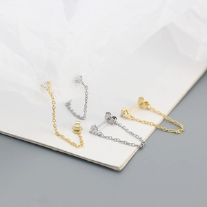 Detailed view of S925 sterling silver chain earrings with claw-set crystals in gold and silver