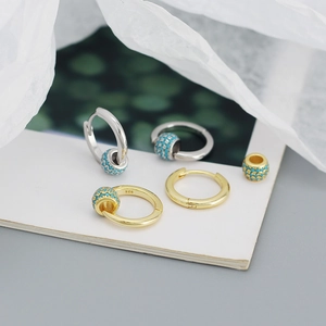 Detailed view of S925 sterling silver hoop earrings with rotating turquoise beads and stones