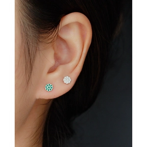 Macro shot of s925 silver flower stud earrings with green and white enamel finish