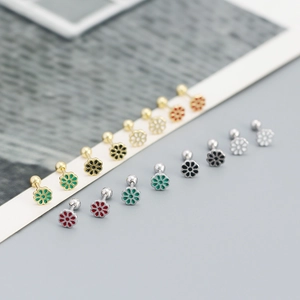 Macro detail of flower stud earrings with colorful enamel and screw-back closure
