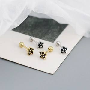 Macro view of flower studs with black zircon and threaded screw ball backing