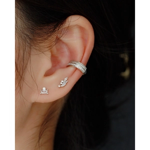 Close-up of S925 silver leaf earring and crystal ear cuff set on a female model