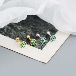 Detail view of daisy flower stud earrings with green enamel inlay and screw back closure