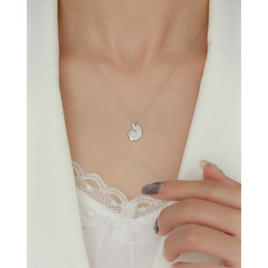 Close-up of S925 sterling silver shell pendant necklace worn on female model neck