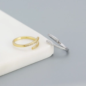 Macro shot of minimalist gold and silver S925 rings with micro-pave zircon detailing