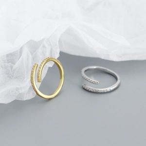 Detailed view of spiral open rings with micro-pave cubic zirconia in gold and silver