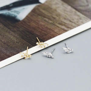 Close-up of S925 silver leaf earrings in gold and silver with white zircon stones
