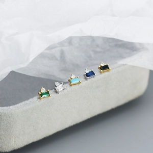 Macro detail of geometric S925 silver stud earrings with colorful rectangular zircons