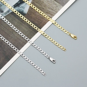 Detail of gold and silver S925 Cuban link chains with secure lobster clasp closures
