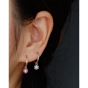 Close-up of S925 silver hoop earrings with colorful zircon flower pendants on ears