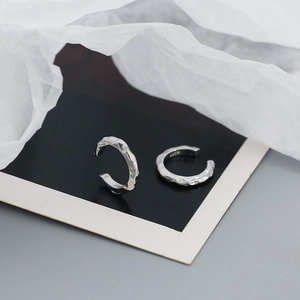 Detail showing the S925 hallmark and irregular hammered texture on these silver ear cuffs