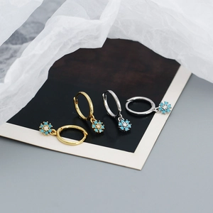 Detailed close-up of s925 silver flower hoop earrings with blue zircon in gold and silver