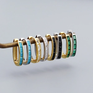 Macro shot of U-shaped s925 silver hoop earrings with rectangular multi-color zircons