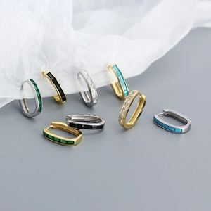 Close-up of U-shaped s925 silver earrings with colorful rectangular zircon stones