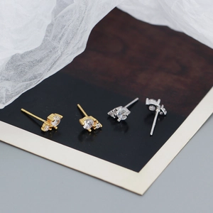 Detailed view of 925 silver stud earrings with three zircons in gold and silver finishes