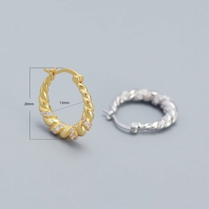 Macro view of twisted S925 silver hoop earrings with 20mm outer diameter and pavé stones
