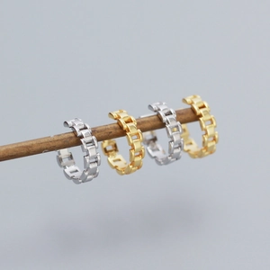 Detailed macro view of S925 silver and gold watch link chain ear cuffs in a row
