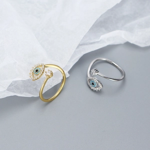 Detailed view of gold and silver S925 sterling silver evil eye rings with blue stones